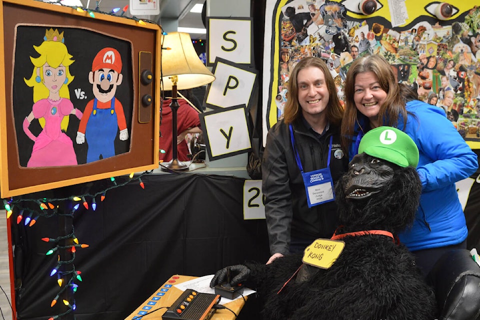 Vernon Winter Carnival executive director Kris Fuller (right) and judge Curt Reimer have a visit with Donkey Kong while visiting businesses in the Best Decorated Premises competition of the 64th Vernon Winter Carnival, which begins today, Friday, Feb. 2. The theme is Carnival of Games. (Wayne Emde Photo) 