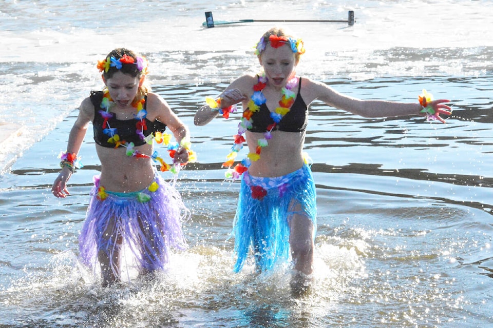 Amelia Chalifoux and Isabella Grimmer plunge to raise funds for their secondary school volleyball team trip to Hawaii in March. (Monica Lamb-Yorski photo - Efteen) 
