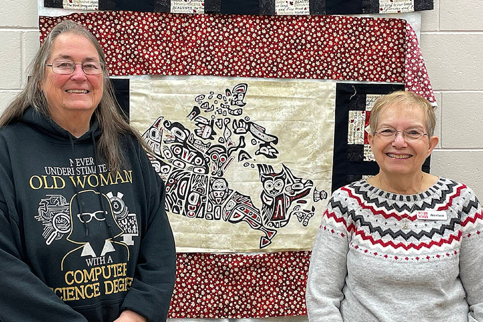 Quilts of Valour representatives Lezley Zwall (L) and Nerissa Thomas with one of the quilts under construction on Quilts of Valour National Sewing Day, Feb. 2. Photo contributed 