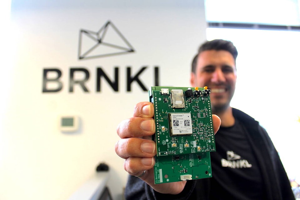 Barnacle Systems CEO Brandon Wright shows components of the company’s BRNKL boat monitoring system. (Jake Romphf/News Staff) 