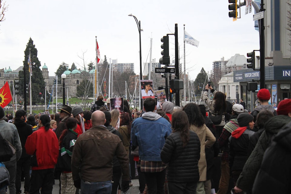 The Stolen Sisters March pauses at an intersection as drums and song lead the crowd on its walk from Pandora Avenue to the Legislature. (Thomas Eley/News Staff) 