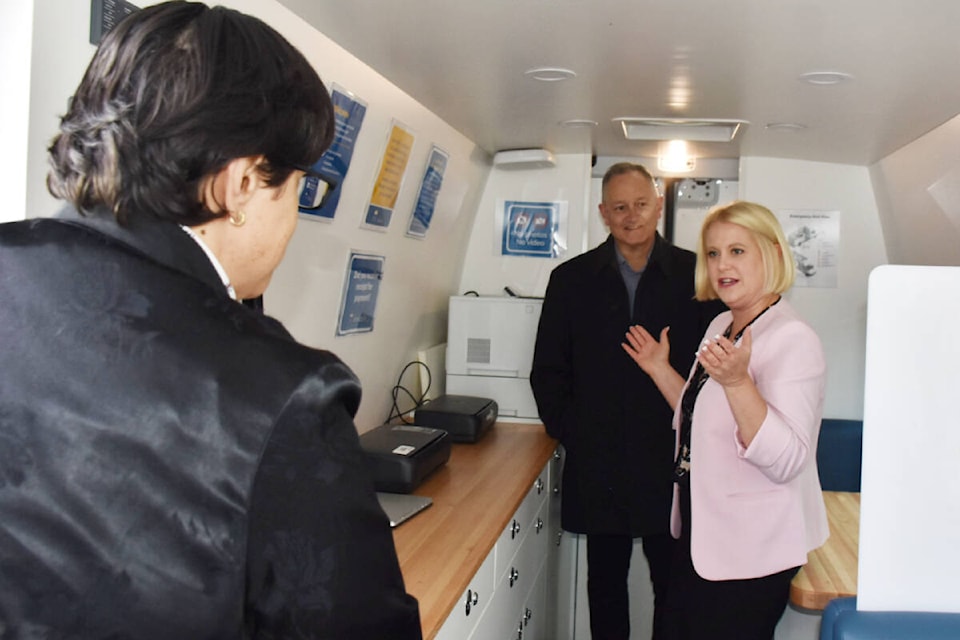 Maple Ridge-Mission MLA Bob D’Eith, Minster of Citizens’ Services Lisa Beare, get a tour of the new Mobile Outreach BC Service van. (Colleen Flanagan/The News) 