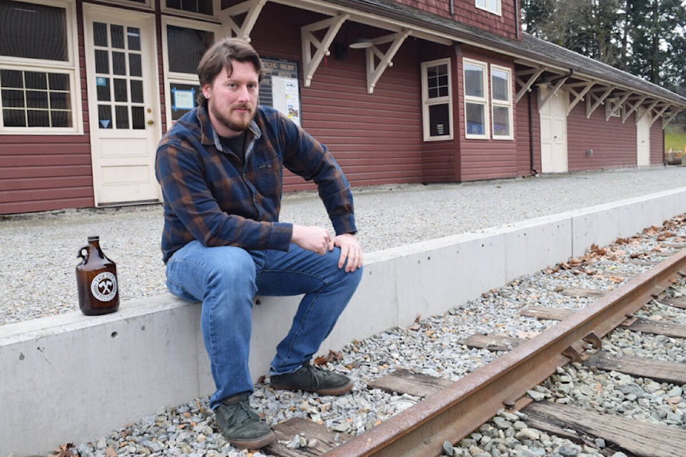 Aaron Colyn, the owner of Twin City Brewing, sits outside of the Port Alberni train station. Twin City Brewing will be opening a second location, The Station Taphouse, in the train station in late 2024. (ELENA RARDON / Alberni Valley News) 
