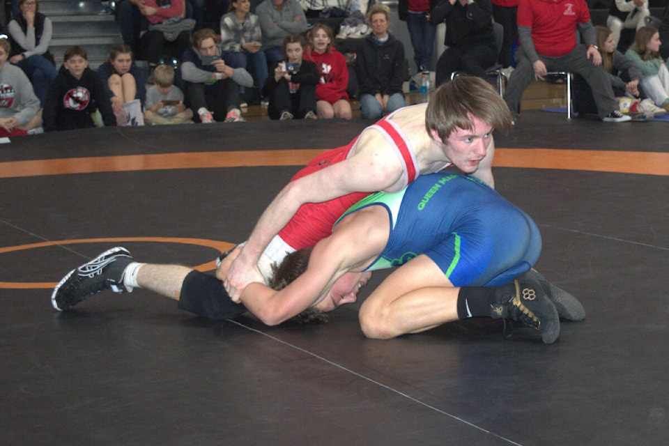 Alex McKenzie (in red) grapples with his opponent in the male 63kg category. McKenzie won Most Outstanding Male wrestler at the Vancouver Island Secondary School Wrestling Championships. (SUBMITTED PHOTO) 