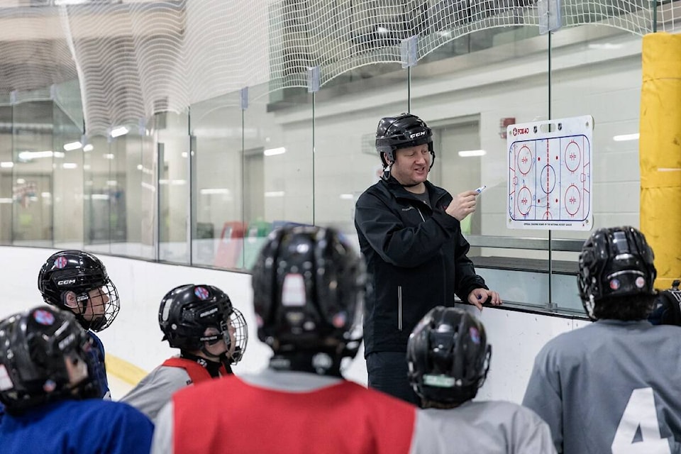 Head coach Jeff Bowden holds some chalk talk in between drills. Photo courtesy of Thorsten Gohl 