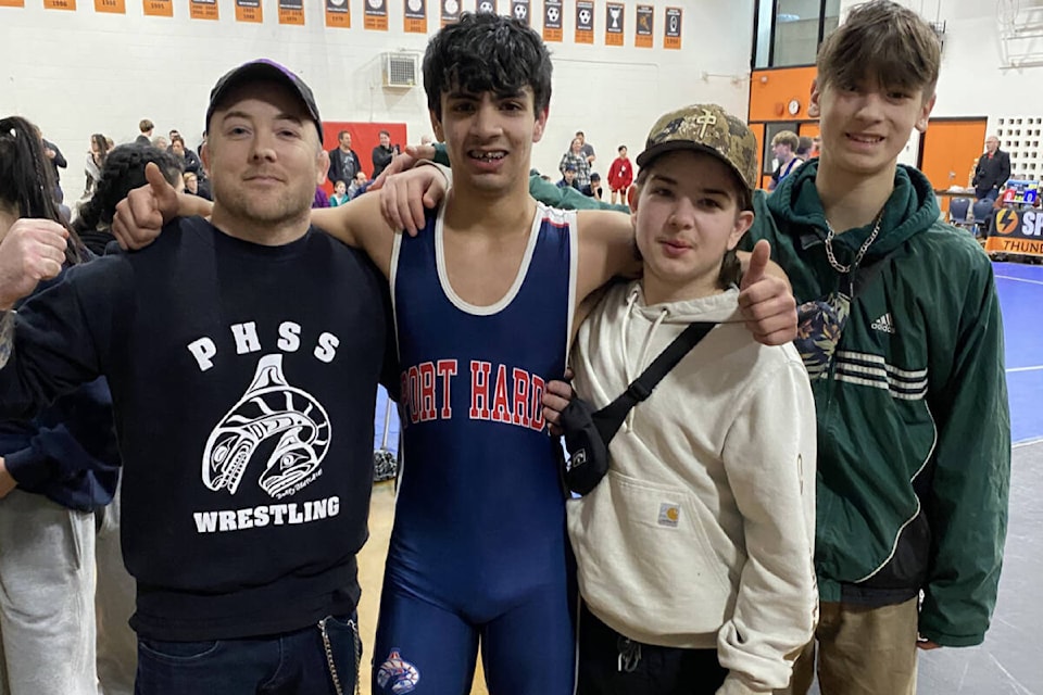 From left to right, PHSS Wrestling assistant coach Tyson Whitney, Grade 12 student Sheldon Frank, Grade 10 student Anthony Blacha, and Grade 9 student Auzton Shaw, celebrate Frank winning his final match of the day and qualifying for the B.C. Provincial Championships. (Paul Cagna photo) 