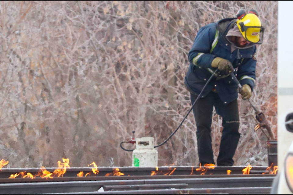 CPKC workers appeared to be using a small propane tank and heat torch on the tracks in downtown Ponoka on Feb. 8. (Emily Jaycox/Ponoka News) 