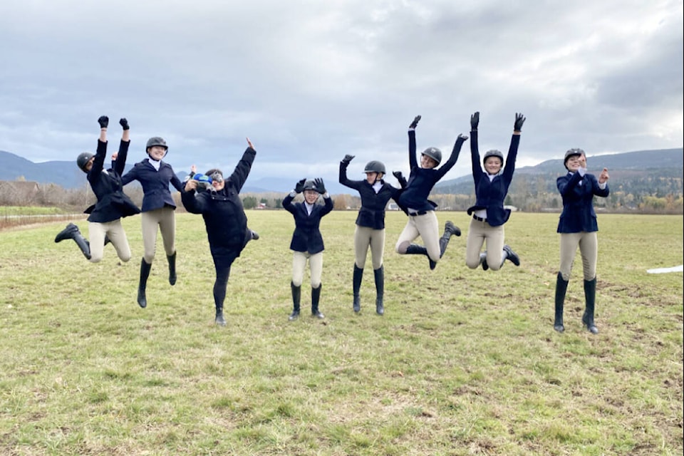 The Queen Margaret’s School Interscholastic Equestrian Association hunt seat team shows its excitement over taking part in the first show at Burkwood Farm in Blaine, Washington in November, earning podium placements in both individual and team events. (Photo by Queen Margaret’s School) 