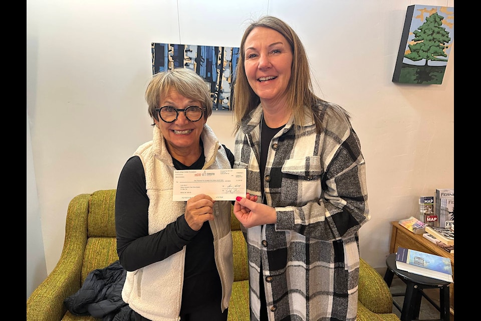 Margorie Grime, left, passes a $1,540 cheque to Elkford Women’s Task Force Society executive director Kim Bauer. Grime raised money for a few Canadian women’s shelters through a trek to Ecuador (Photo courtesy of Margorie Grime) 