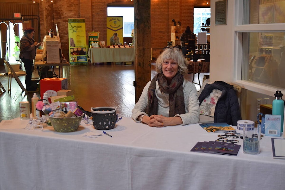 Host Anne Marie Tosse greets guests as they arrive at the Uplift Your Wellness Expo at 鶹AV’s Laurel Packinghouse on Feb. 11, 2024. (Brittany Webster/Capital News) 