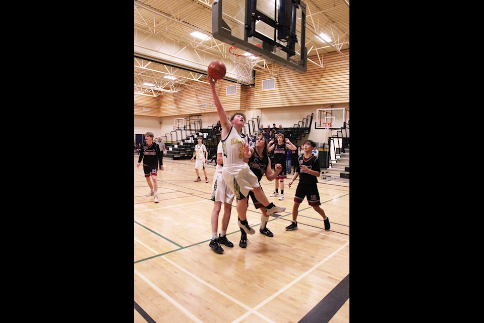 PSO Eagles Oland Vickers leaps in to tip his own rebound into the net during a game against the LCSS Falcons. (Patrick Davies photo - 100 Mile Free Press) 