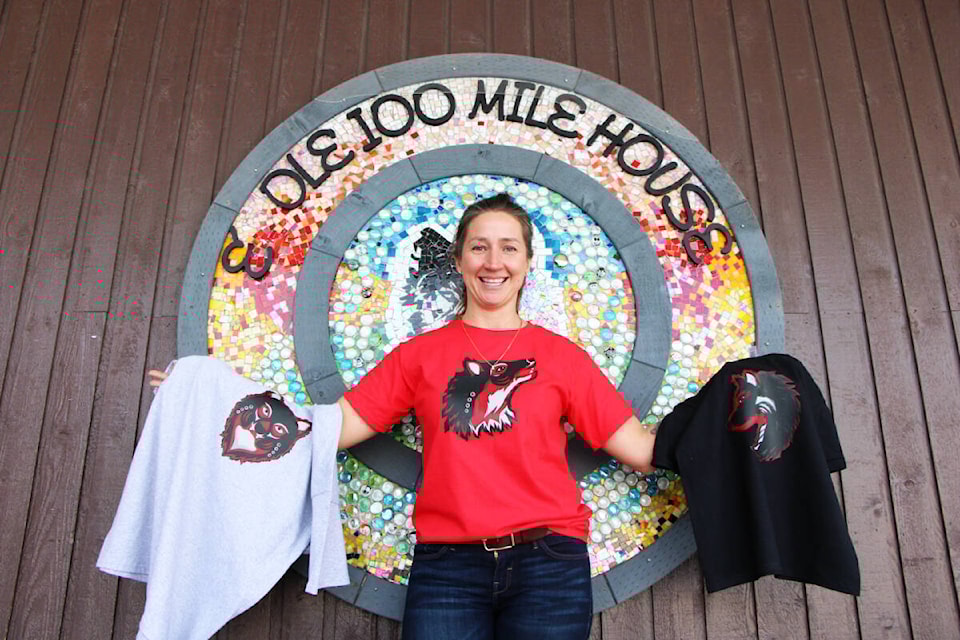 100 Mile Elementary School principal Crystal Dawn-Langton shows off the new House Team Jerseys created by Tsq̓éscen̓ First Nation artist Brent Dixon. (Patrick Davies photo - simplymastery) 
