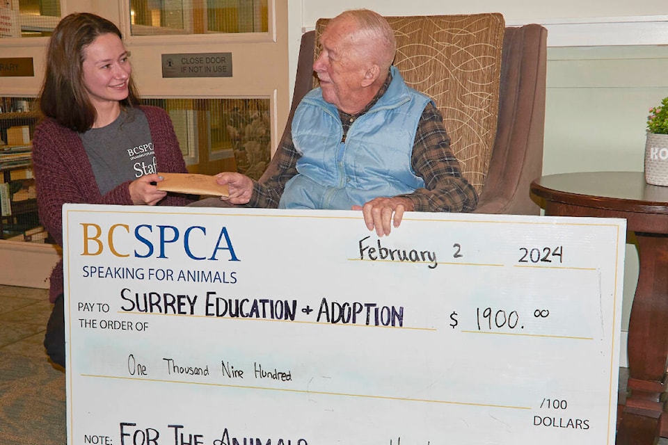 The Surrey SPCA’s Brenna Rocliffe was on hand Feb. 2, 2024 to accept proceeds from the 2024 Dogs of White Rock calendar from Harold Zelt, the White Rock senior whose love of dogs and photography led to the fundraiser. (Mike Zelt photo) 