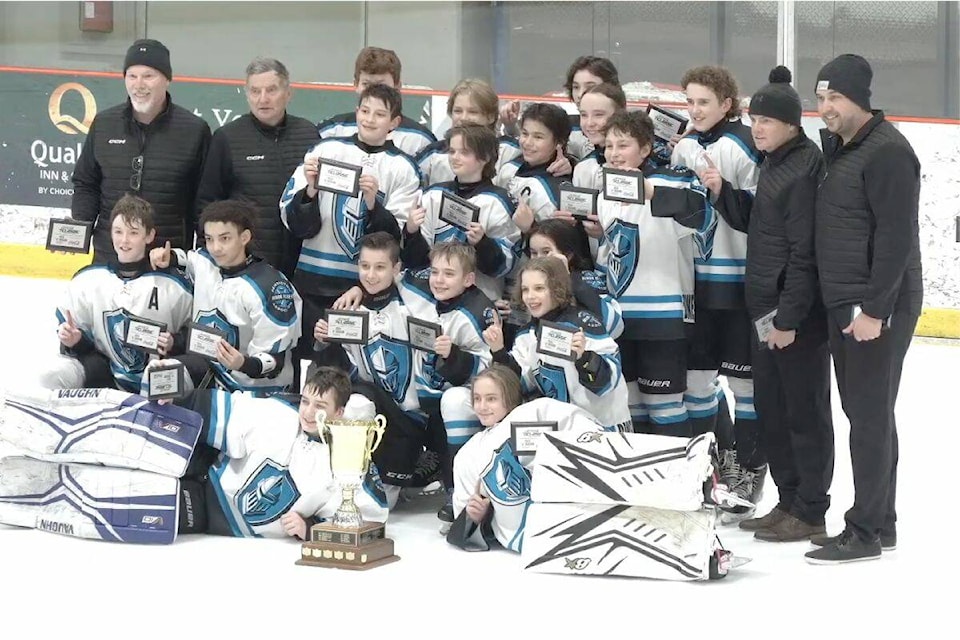 The Penticton Knights pose with their trophy after defeating the Vernon Mustangs in the Coca Cola Pee Wee Classic at Kal Tire Place North. 