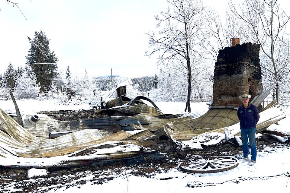 Art Joyce of Hanceville stands in front of the former Chilcotin Log Church, lost to a fire on Saturday, Feb. 10. Joyce was a pastor for 30 years at the church and lives 46 metres from the church. (Juri Agapow photo) 