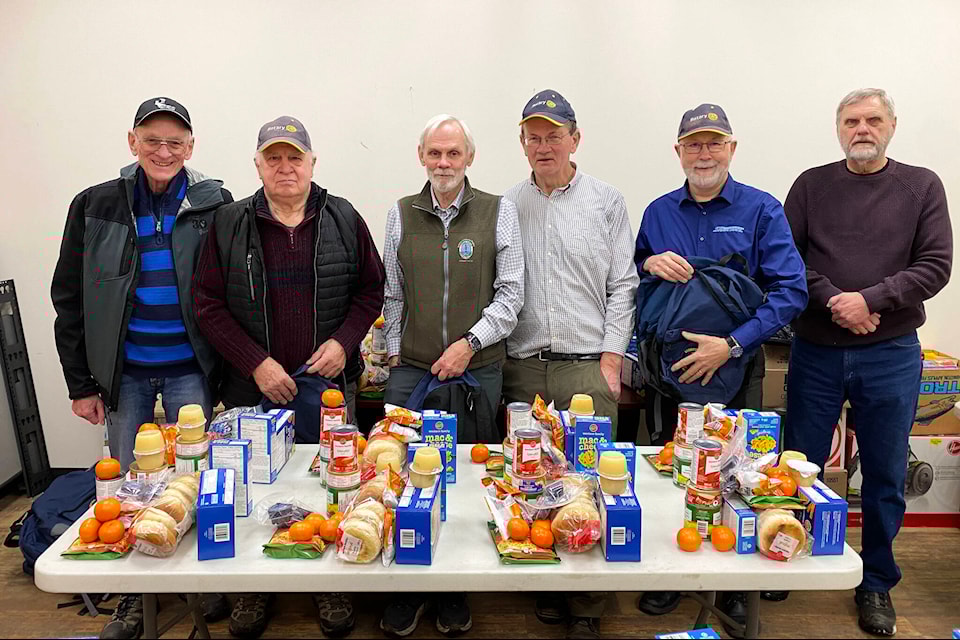 Members from the Rotary Club of Williams Lake gather at Sandtronic Business Systems early morning on Feb. 8 to pack backpacks full of food for students in need as part of the Starfish Pack program. Pictured are Bill Carruthers (from left), Renni Johnson, Leo Rankin, Ken O’Brien, Ingolf Sandberg and Ted Matoga. (Kim Kimberlin photo - Efteen) 