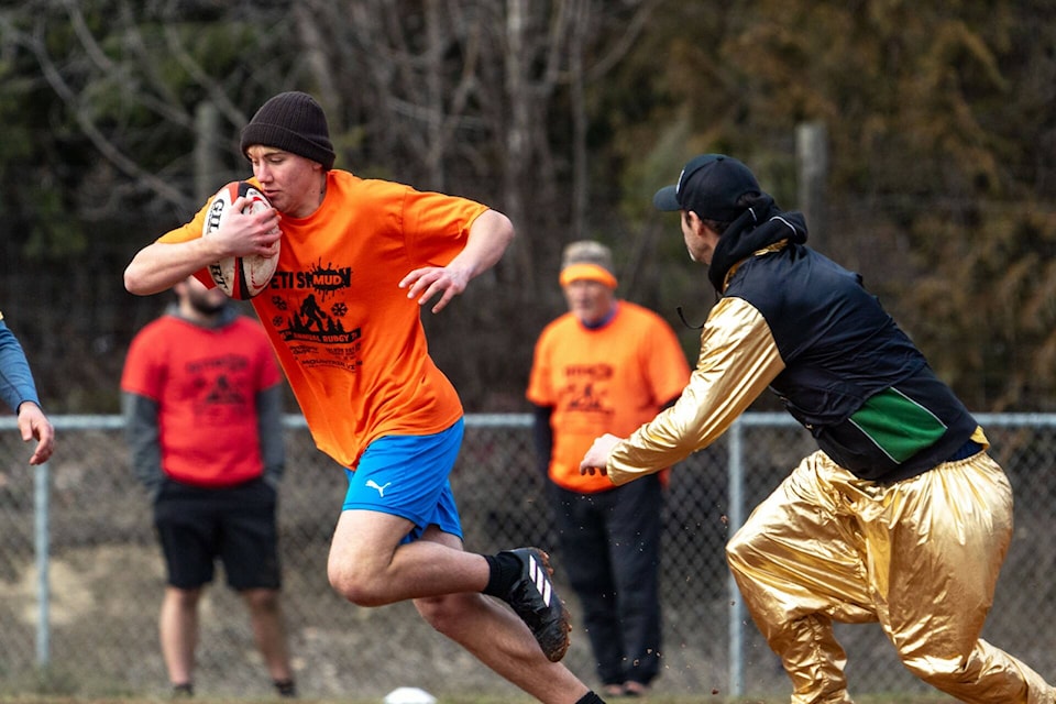 Ziah Jackson, left, from Trail avoids the flashy Jeff Miller of Enderby during Yeti Rugby’s 26th Annual Snow 7s tournament, dubbed the Mud 7s this year due to the milder weather, held at the Salmon Arm Elk’s Hall on Feb. 10. (Selina Metcalfe-Ihana Images photo) 