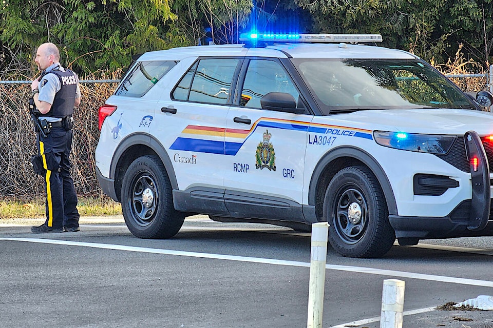 A Langley RCMP officer redirected traffic after a crash on 16th Avenue between 240th and 248th Street closed that section of the route to traffic for about eight hours on Monday, Family Day, Feb. 19. (Dan Ferguson/Langley Advance Times) 