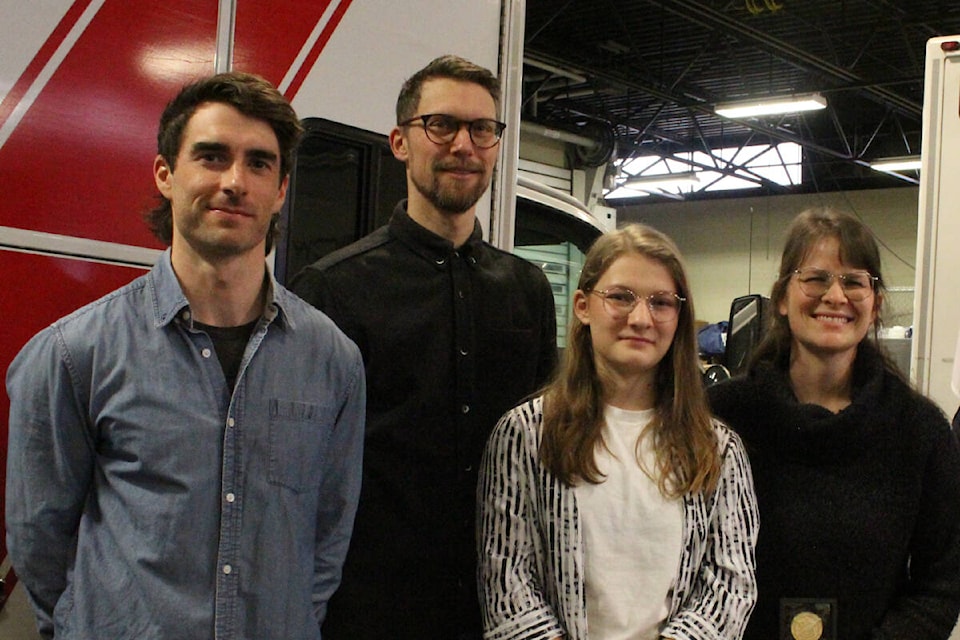 Paramedic Jared Kowelchuk (left) with Will, Sarah and Mabel Krzymowski (right) in Victoria on Feb. 20 as they were honoured for saving the life a person who was in cardiac arrest. (Mark Page/News Staff) 