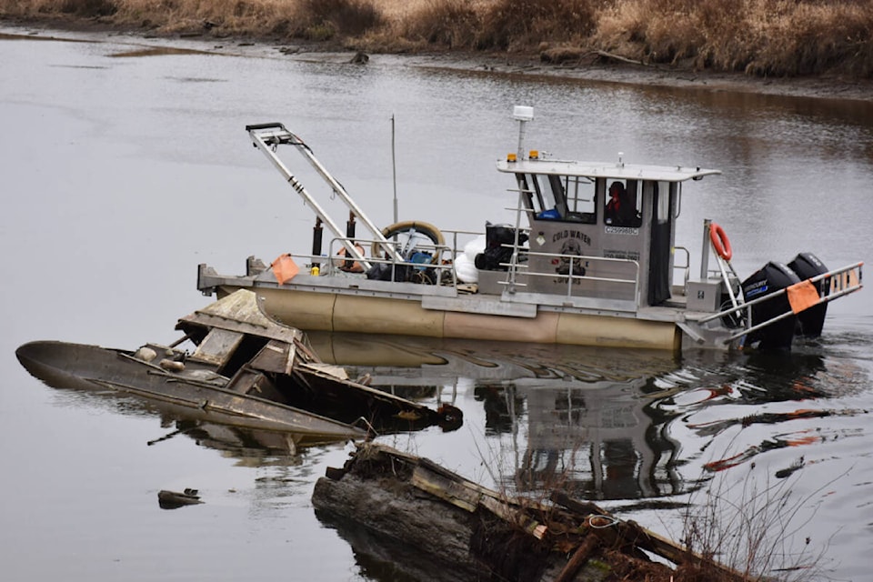 Work is underway to clean up the dead boats and debris in the Alouette River. (Neil Corbett/The News) 