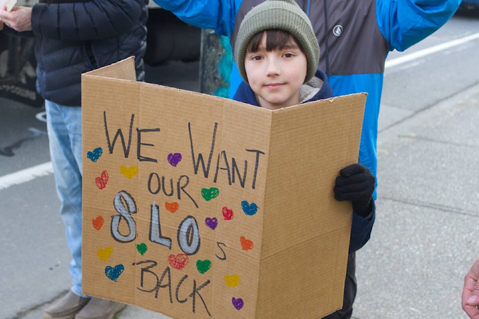 Grade 4 Thomas was amongst one of the dozen at the rally for school liaison officers to return to Greater Victoria schools. (Ella Matte/News Staff) 