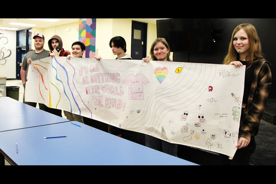 Students at Peter Skene Ogden Secondary School show off a mural the school completed this week for Pink Shirt Day. (Patrick Davies photo - simplymastery) 