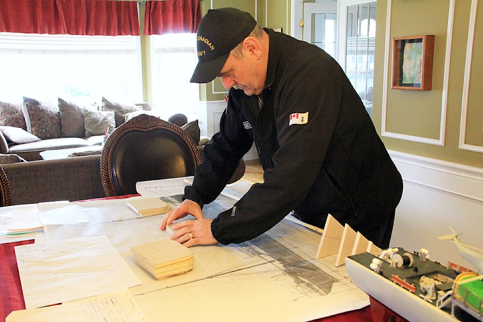 Yvon Lehoux arranges pieces for the hull of a new ship he’s working on, the SS Komagata Maru. (Photo: Malin Jordan) 
