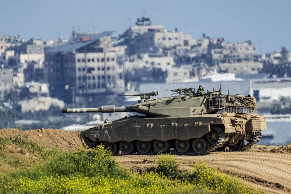 An Israeli soldier on top a tank on the border with the Gaza Strip, in southern Israel, Sunday, March 10, 2024. The army is battling Palestinian militants across Gaza in the war ignited by Hamas’ Oct. 7 attack into Israel. (AP Photo/Ariel Schalit) 