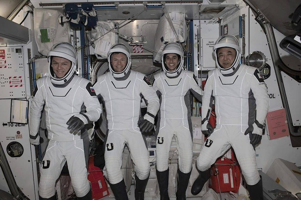 This undated photo provided by NASA shows four Expedition 70 crew mates posing in the pressure suits they will wear when they return to Earth aboard the SpaceX Dragon “Endurance” spacecraft. From left, Roscosmos cosmonaut Konstantin Borisov, ESA (European Space Agency) astronaut Andreas Mohgensen, NASA astronaut Jasmin Moghbeli, and JAXA (Japan Aerospace Exploration Agency) astronaut Satoshi Furukawa. The quartet splashed down off the coast of Florida on Tuesday, March 12, 2024, completing a six-and-a-half-month space research mission. (NASA via AP) 