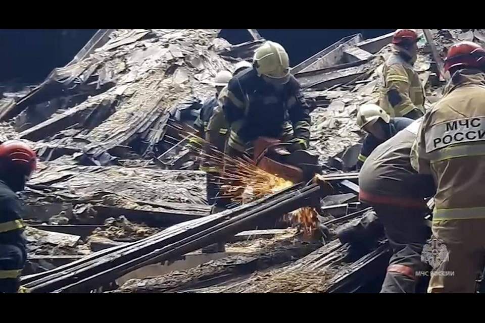 In this photo taken from video released by Russian Emergency Ministry Press Service on Sunday, March 24, 2024, rescuers work in the burned concert hall after a terrorists attack on the building of the Crocus City Hall on the western edge of Moscow, Russia. Russia’s top state investigative agency says the death toll in the Moscow concert hall attack has risen to 133. The attack Friday on Crocus City Hall, a sprawling mall and concert venue on Moscow’s western edge, also left many wounded and left the building a smoldering ruin. (Russian Emergency Ministry Press Service via AP) 