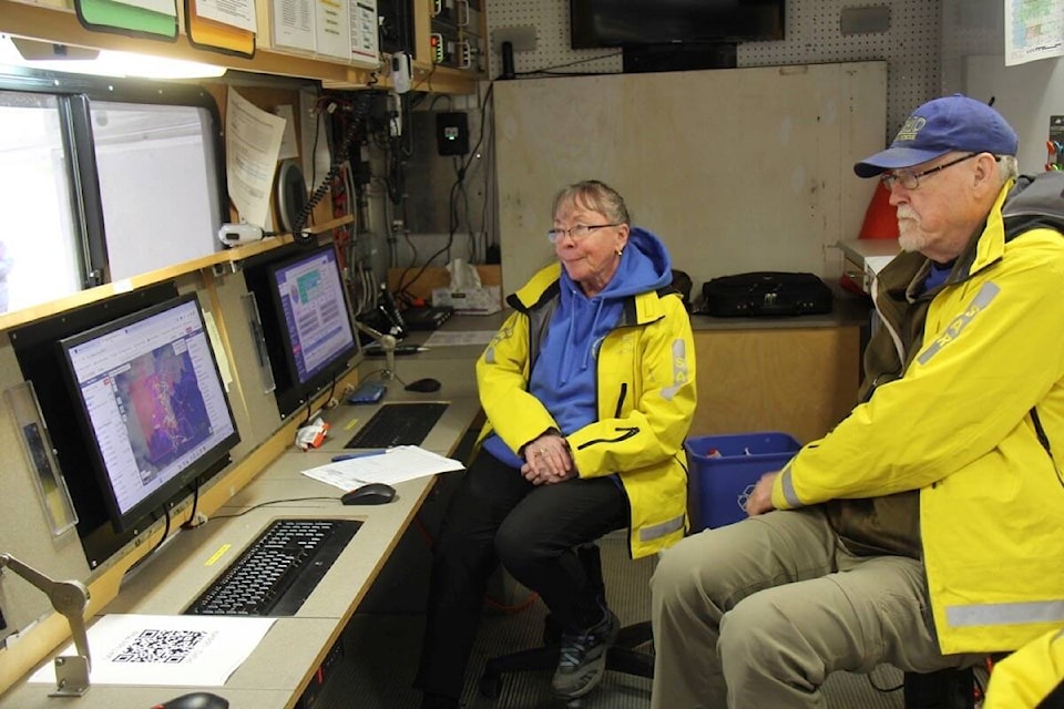 Radio operator Jeannie Nielsen and SAR manager Jack Johnson, volunteers with the Peninsula Emergency Measures Organization SAR team, work in the truck during training near Willis Point Fire Hall.