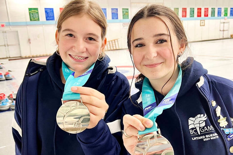 Williams Lake youth curlers Kelsey Camille and Talana Brown-John show off their Lhtako 2024 BC Winter Games medals they won in curling. (Angie Mindus pgoto/Efteen) 