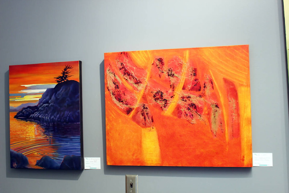 Kathryn Huse’s ‘Broken Islands Sunset’, left, and Joanie Winnitoy’s mixed media. (Photo by Don Bodger) 