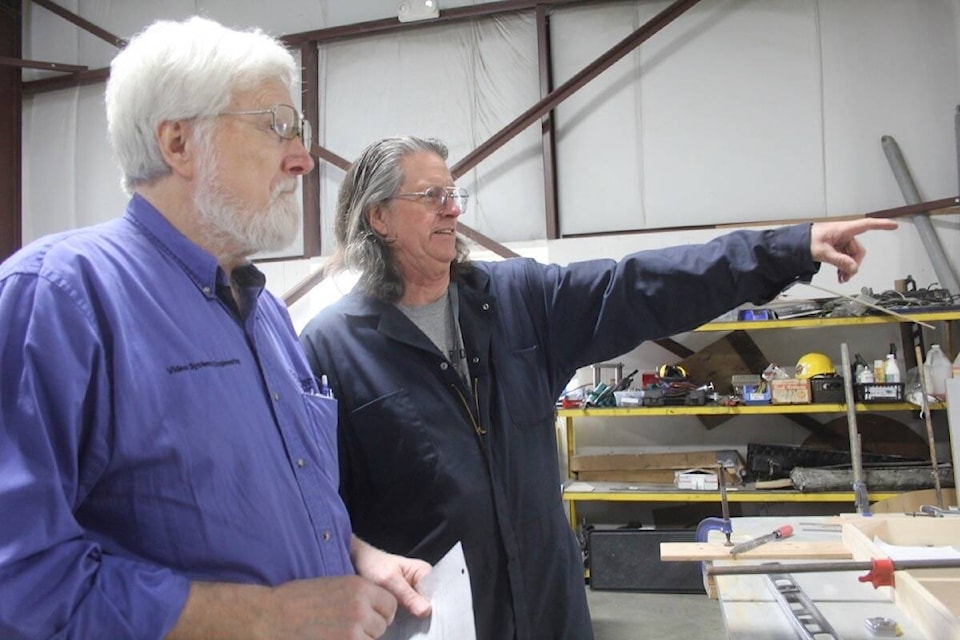 Gary Powe, left, serves as project lead on the Avro Lancaster FM104 restoration underway at the BC Aviation Museum adjacent to the Victoria International Airport. (Christine van Reeuwyk/News Staff) 