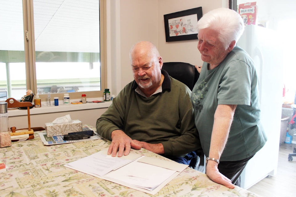 Danny and Marlaine Williams look over a letter from their bank pertaining to the fraudulent obtaining of funds from their account. (Photo by Don Bodger) 