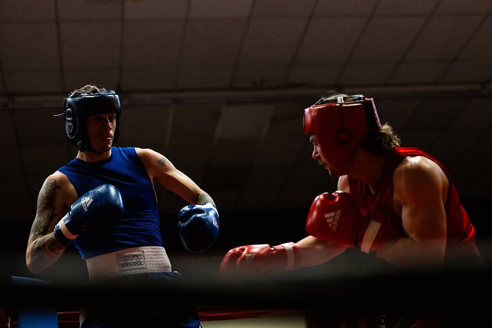 Local Fernie boxer Michael Hutchinson, in red, faces off against Kelowna Madkatz Boxing Club’s Christian Geddes at Judgement Night V on March 24 (Photos by Vince Mo Media) 