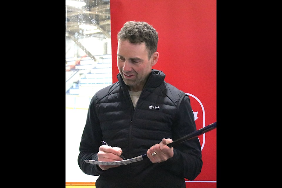 Dan Hamhuis signs a stick for a young fan during a hockey clinic in Smithers last summer. (The Interior News archives) 