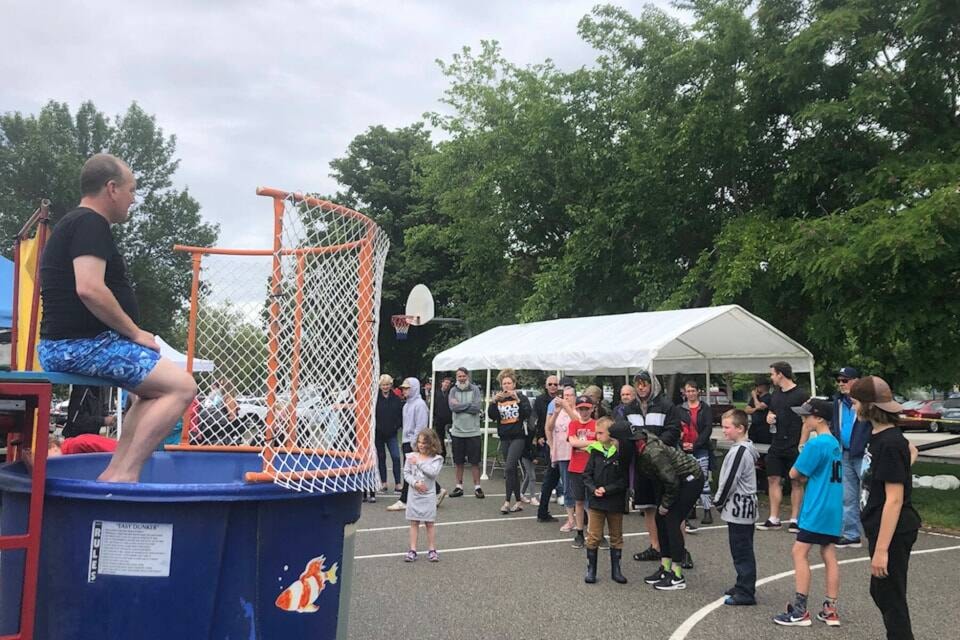 Despite being sick, Jerome Abraham braved the dunk tank at Discovery House’s Father’s Day event in 2022 where he personally raised over $18,000 for the recovery house. His son threw the first balls to dunk his dad. (Monique Tamminga Western News) 