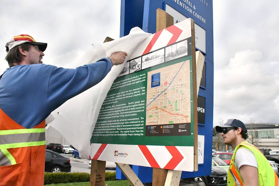 Armin Valentin, a tradesman with the parks department, and parks labourer Colten Burr (right) installed signs about local rail history at Innes Corners on Feb. 29, 2024. (Heather Colpitts/91ԭ Advance Times) 