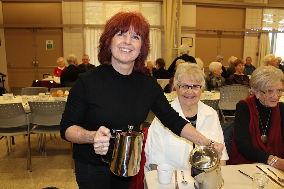 Carol Sexton volunteers at the heritage dinner and pours coffee for Julie Rutter. (SONJA DRINKWATER PHOTO) 