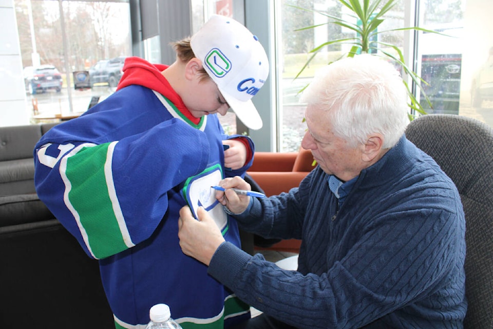 Vancouver Canucks’ alumni ‘King Richard’ Brodeur signs a jersey for Bodhi Dunk, 12, during the Canucks’ Tundra Tour at Alberni Toyota on March 2, 2024. (SONJA DRINKWATER PHOTO) 