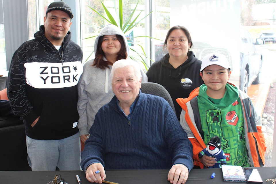 Simon Joseph, left, Kaida Joseph, Irene Hanson and Kassian Joseph are all smiles as they have a photo taken with Vancouver Canucks alumni Richard Brodeur during the Canucks Tundra Tour at Alberni Toyota on March 2, 2024. (SONJA DRINKWATER PHOTO) 