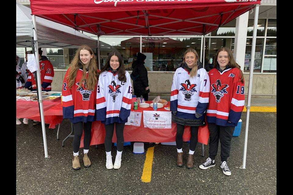 The U18 North Island Impact held a barbecue fundraiser on Saturday at the IGA in Port McNeill, raising $2,290 for their trip to Armstrong to compete at the Single A BC Provincial Championships. From left to right, Impact players Mecca Humphrey, Emma Walkus, Adysen Vergbrugge, and Bella Stewart. (Tyson Whitney - North Island Gazette) 