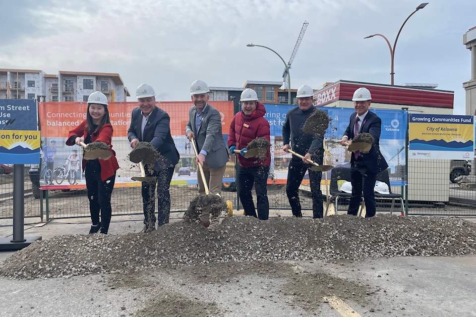 (L-R) B.C. Municipal Affairs Minister Anne Kang, Mayor Tom Dyas, Coun. Loyal Wooldridge, Coun. Luke Stack, Coun. Gord Lovegrove and Director of Partnerships and Investments Derek Edstrom participate in a groundbreaking ceremony for the Bertram Street Overpass Project on Fri. Mar. 8, 2024. (Gary Barnes/Capital News) 