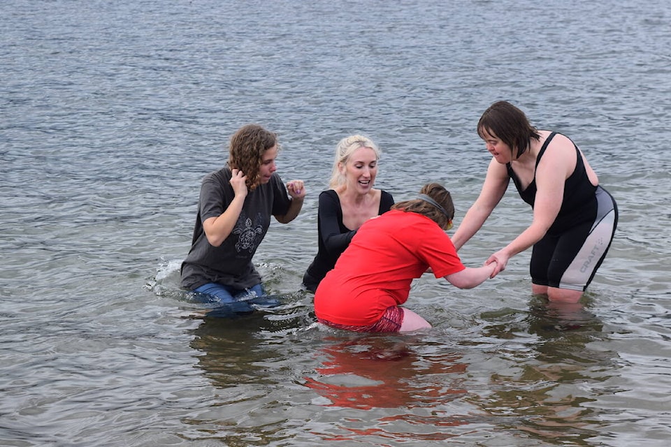Cassidy Rutledge (in red) braves the cold with support from friends at the annual Special Olympics 鶹ѡ Polar Plunge. (Brittany Webster/Capital News) 