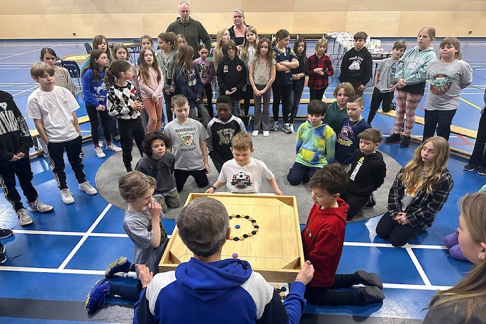 Wilf Pauls teaching students at Mar Jok Elementary the game of pitchnut. (Brittany Webster/West K News) 