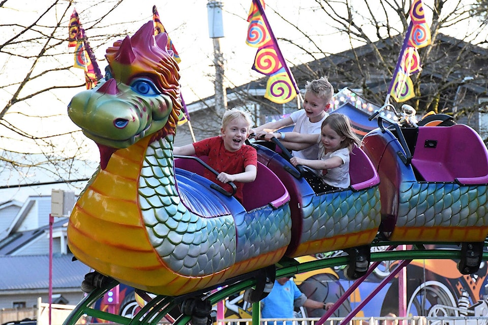 From left, Lincoln Tomlinson, Max Wallace and Evelyn Wallace ride a roller coaster during the West Coast Amusements fair in Chilliwack on Friday, March 15, 2024. (Ryleigh Mulvihill/ Black Press Media) 