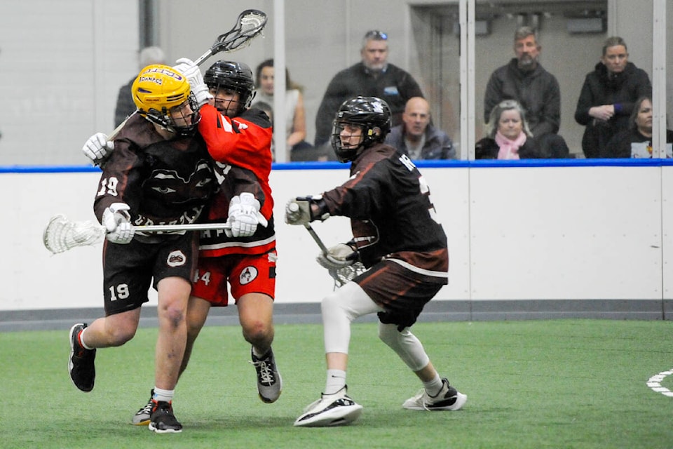Drew Kask tries to step past the check of Ryan Jensen during Arena Lacrosse League West action at Langley Events Centre on March 13. Grizzlies won a third straight game, defeating the Black Fish 12-11 in overtime. (Gary Ahuja/Langley Events Centre/Special to Langley Advance Times) 