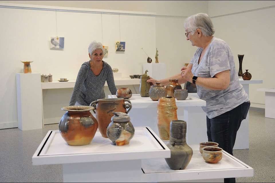 Deb Greenfield (right) of Yarrow and Holly McKeen of Chilliwack help set up ‘Clay 2024 - Passionate About Clay’ at the Chilliwack Cultural Centre on Tuesday, March 19, 2024. (Jenna Hauck/ Chilliwack Progress) 