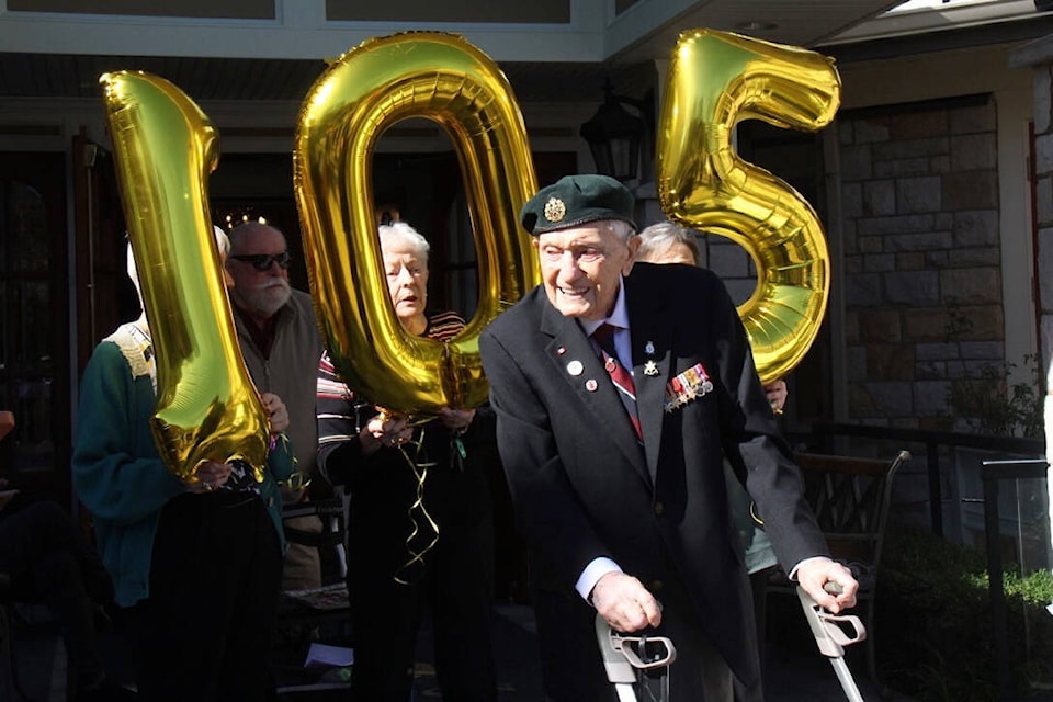 Friends and fans gather to cheer centenarian philanthropist John Hillman on his 105th birthday and last ceremonial lap of the Carlton House courtyard. (Christine van Reeuwyk/News Staff) 